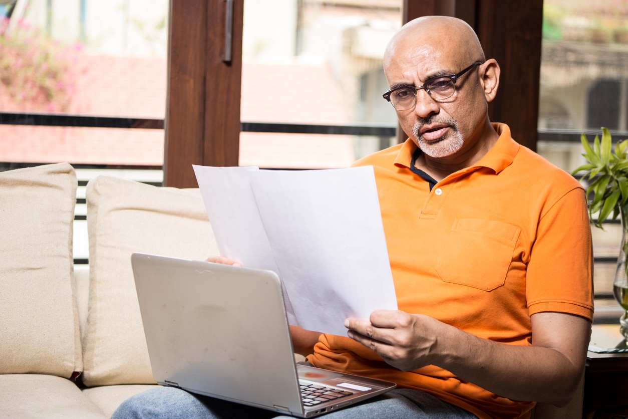Midlife man reviewing insurance policy